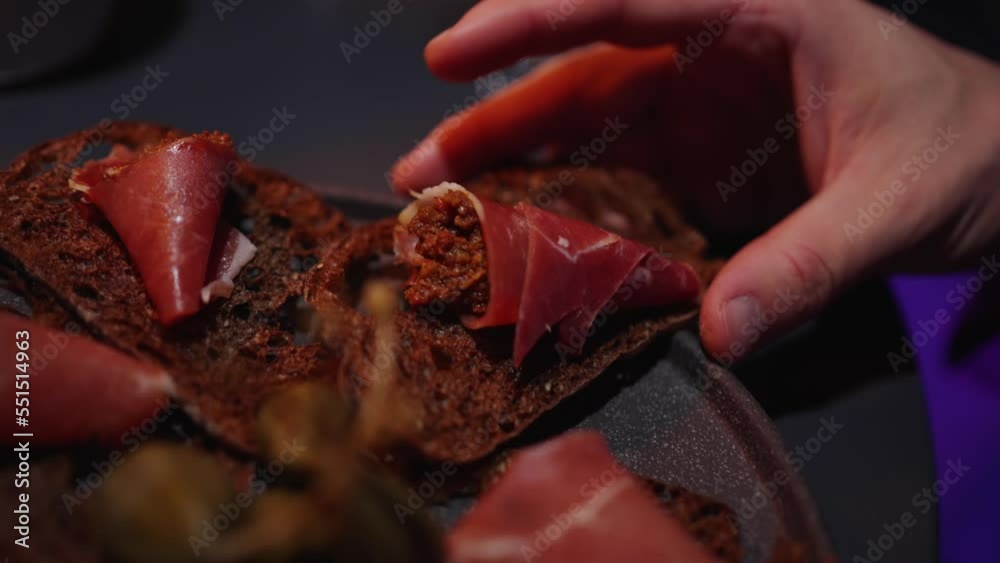 A man takes a sandwich with his hands A man takes a sandwich with his hands