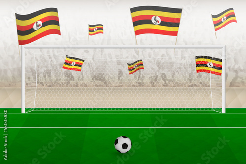 Uganda football team fans with flags of Uganda cheering on stadium, penalty kick concept in a soccer match.