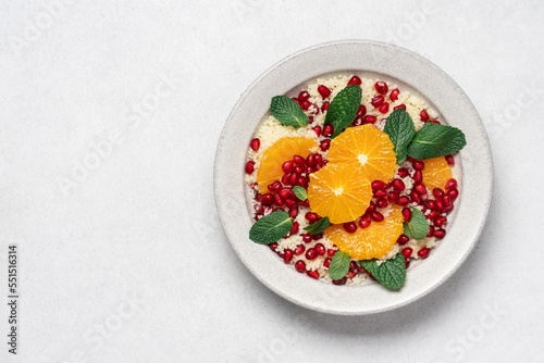 Couscous salad with oranges, pomegranate seeds and mint. Seasonal fruit salad. middle eastern food