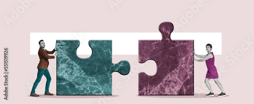 A man and a woman are putting together puzzle pieces.
