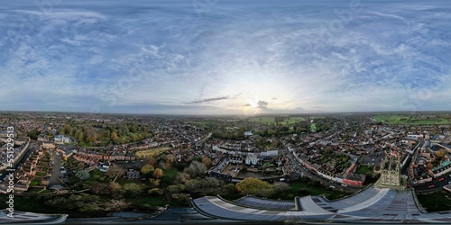 Aerial panoramic shot of old buildings surrounded by trees, Warwickshire, UK photo