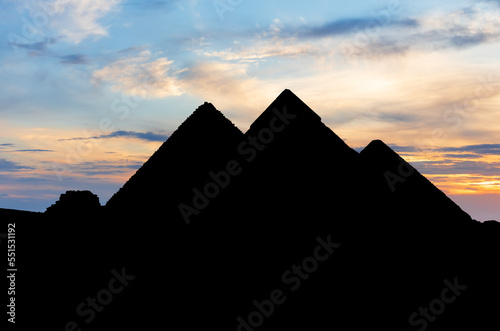 Obraz na płótnie The pyramids in the dark, silhouettes at sunset, Giza, Egypt w salonie