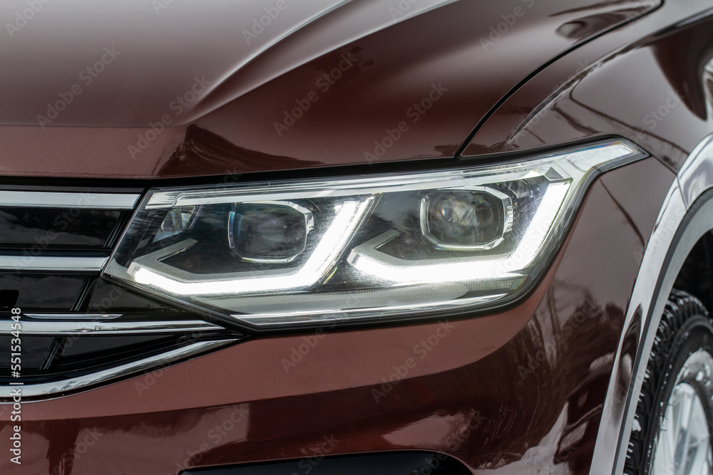 Headlight lamp of new cars. Close up detail on one of the LED headlights modern car. Exterior closeup detail. Closeup headlights of car.