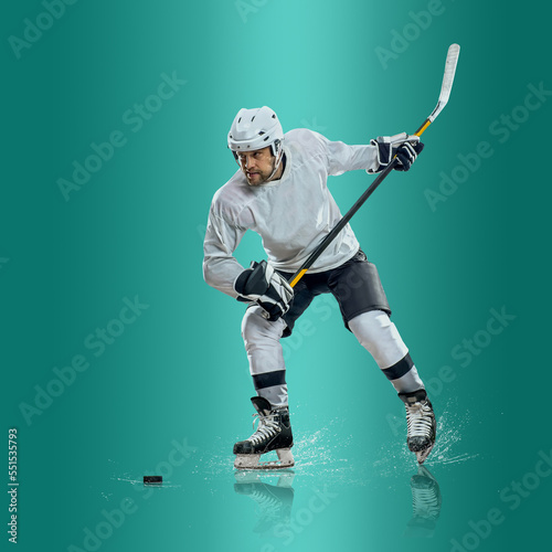 Photography Professional ice hockey player hitting puck for winning goal in action on gradient multicolored neon background