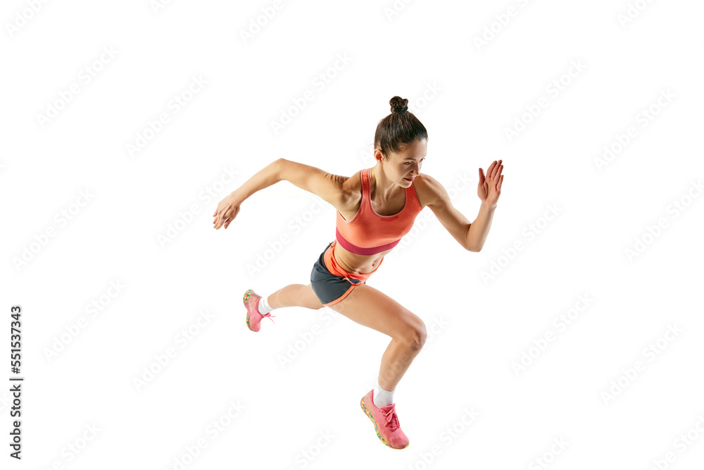 Top view of athlete in motion. Young fitness sportive girl in sports uniform running, training isolated over white background. Dynamic movements, running technique.