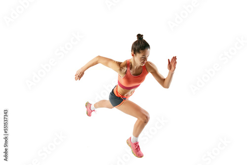 Top view of athlete in motion. Young fitness sportive girl in sports uniform running, training isolated over white background. Dynamic movements, running technique.