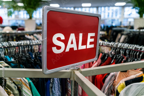 Sale Sign On Rail in Clothes Shop or Store