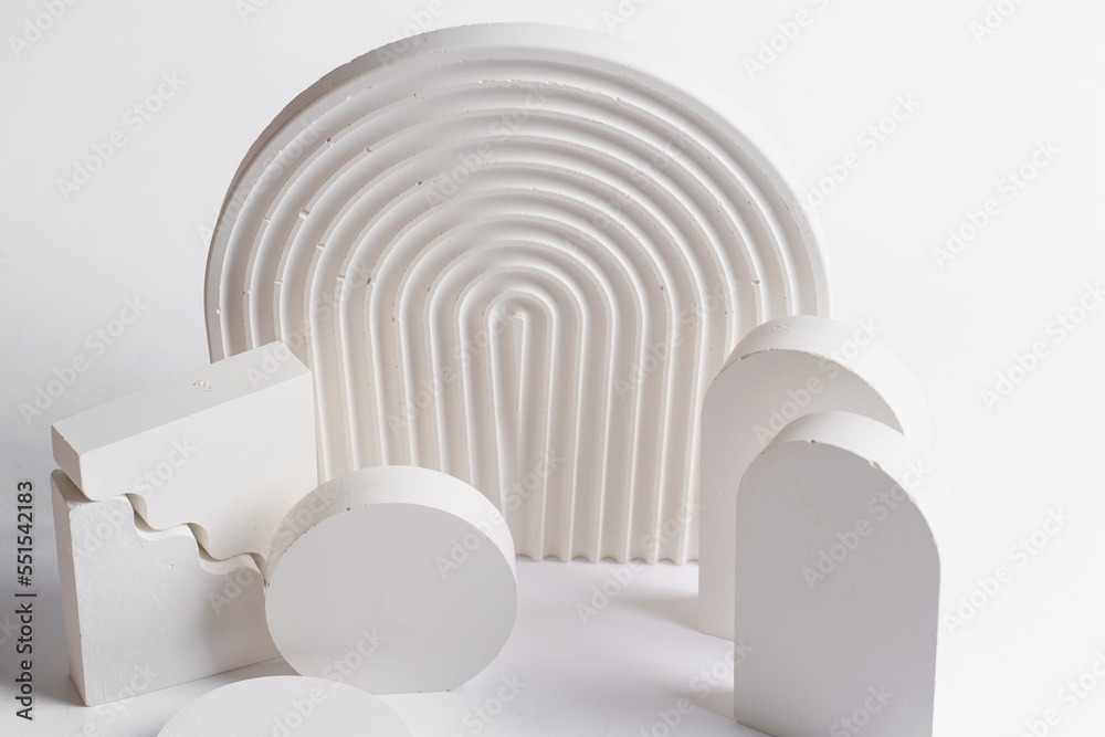 Fototapeta premium White props for product photography on white seamless background - half-circles, oval doors, rippled arch, zig-zag stairs