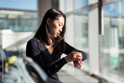 Asian tourist checking time in airport