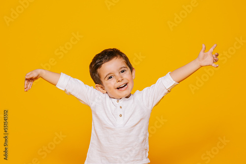 Excited little boy raising arms photo