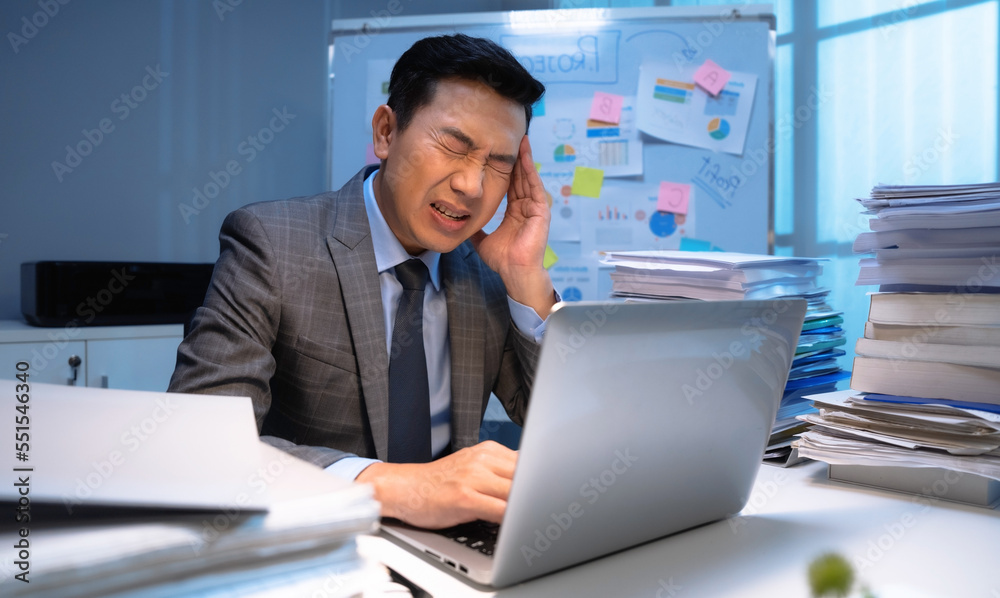 Tired businessman working hard in office at night. Tired businessman working hard in office at night.