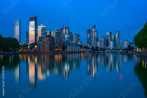 London cityscape Canary Wharf with reflection from Greenland Dock in England at twilight