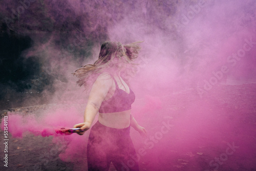 person in pink smoke