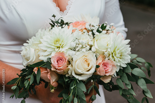 The bridal bouquet held in the bride s hands during the wedding