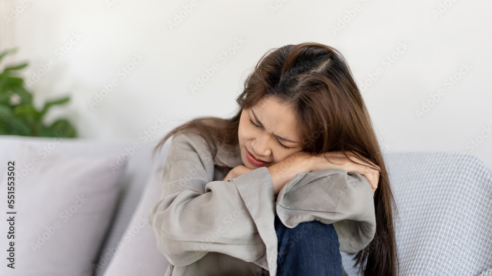 Stressed woman holding her temples with severe problems in her life, Family problems, Pressure from work, Poor financial, Despair in life, discouraged and deeply saddened, Panic attacks. Stressed woman holding her temples with severe problems in her life, Family problems, Pressure from work, Poor financial, Despair in life, discouraged and deeply saddened, Panic attacks.