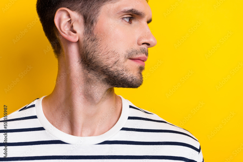 Obraz premium Close up cropped profile photo of serious nice young man look empty space isolated on yellow color background