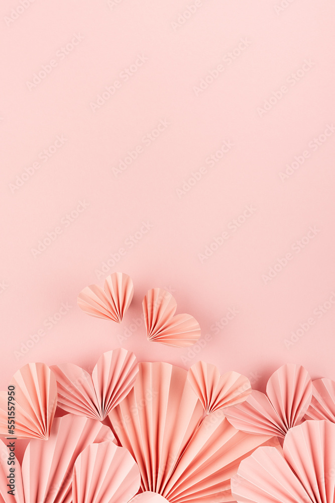 Sweet love background for celebrate wedding or Valentine day - gentle pink paper hearts flying on pink backdrop as footer border, copy space, top view, vertical.