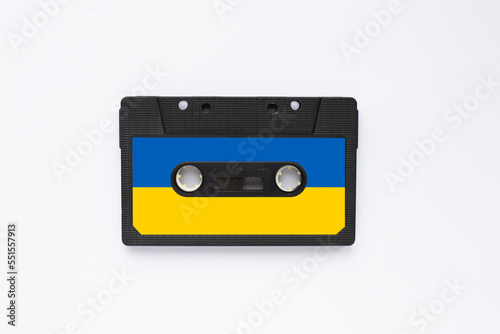Magnetic old tape cassette for audio painted in the color of the ukrainian flag isolated on a white background