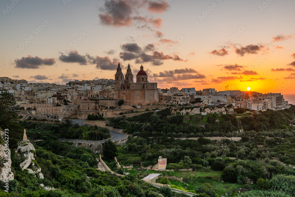 Il-Mellieha, Malta - skyline view of Mellieha town at sunset with Paris Church on hill top Il-Mellieha, Malta - skyline view of Mellieha town at sunset with Paris Church on hill top