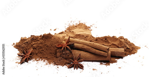 Pile cocoa powder, star anise and cinnamon sticks isolated on white   photo