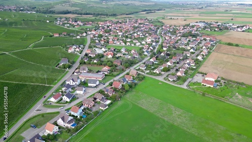 Panoramic aerial drone top view of the rural village of Bergholtz (Upper-Rhine, Alsace, France) in summer day, in the middle of the vineyards of the plain at the foot of the mountains photo