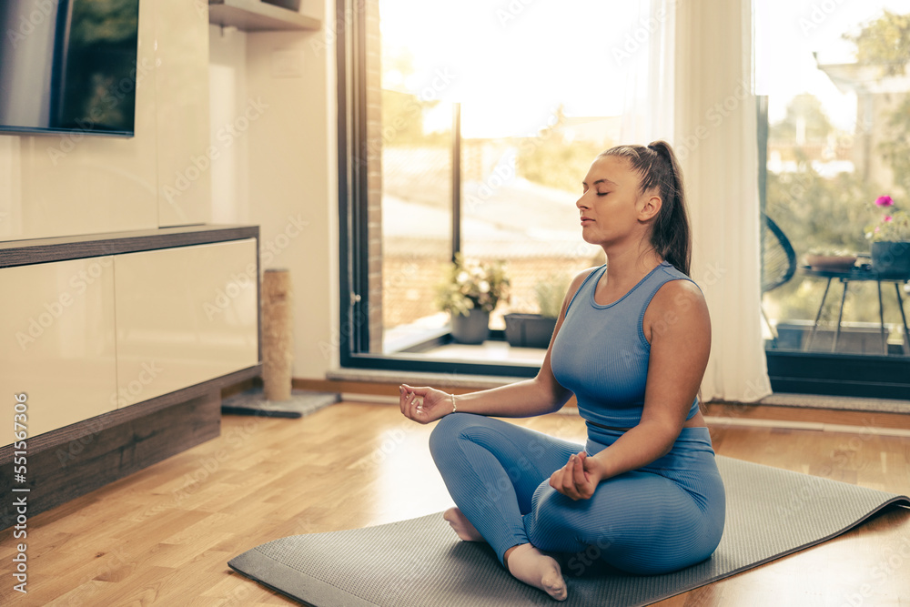 Woman Practicing A Yoga Routine At Home Woman Practicing A Yoga Routine At Home