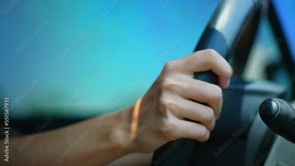 Driver hands holding steering wheel. Closeup female hand driving on road Driver hands holding steering wheel. Closeup female hand driving on road