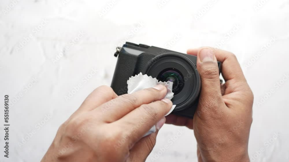 top view of cleaning a camera lenses with a cleaning cloth 