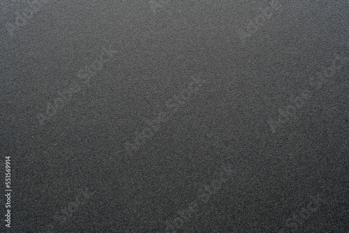 Rough black plastic background and texture. Black plastic material, closeup