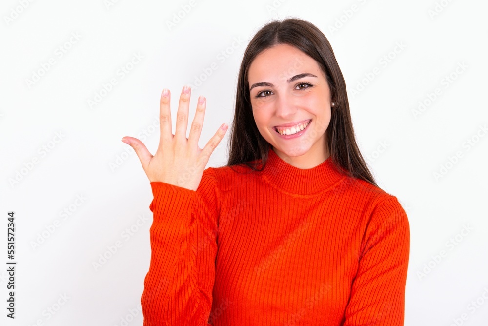 Young caucasian woman wearing red sweater over white background smiling and looking friendly, showing number five or fifth with hand forward, counting down Young caucasian woman wearing red sweater over white background smiling and looking friendly, showing number five or fifth with hand forward, counting down