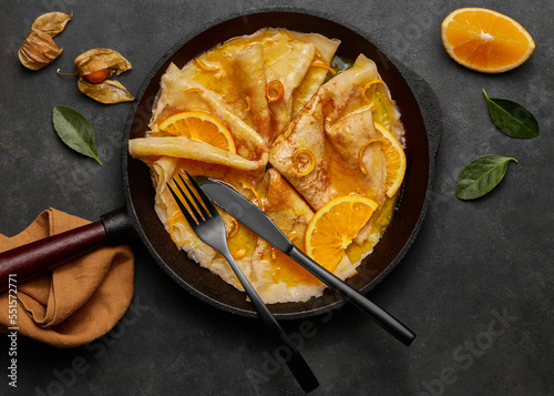 Homemade crepes suzette with orange liqueur and orange slice photo