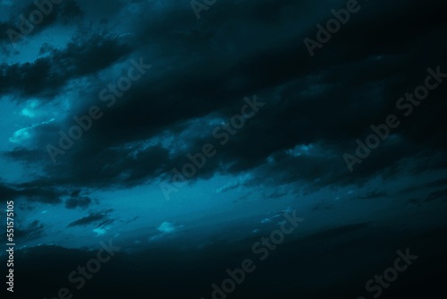 Black green blue night sky with clouds. Dark dramatic skies background for design. Cloudy, rainy, windy, stormy weather. Or a frightening, spooky, creepy, nightmare concept.