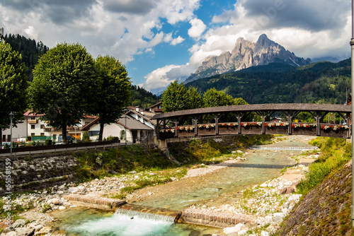 View of a wooden bridge with flowers in Fiera di Primiero, Trentino Alto Adige - Italy