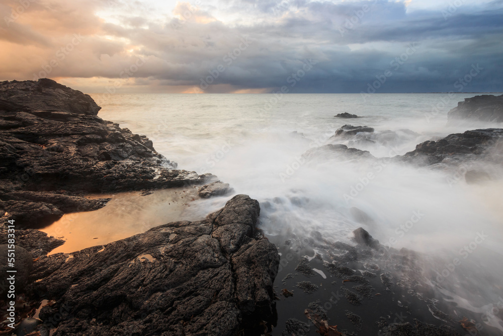 Sea wave on long exposure during sunset on the seashore Sea wave on long exposure during sunset on the seashore