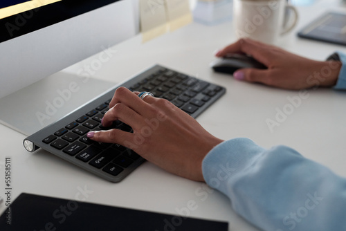 Hands of female programmer working on computer, testing code of new app