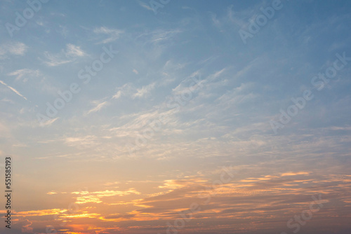 sunset or sun rise sky with rays of yellow and red light shining clouds and sky background and texture