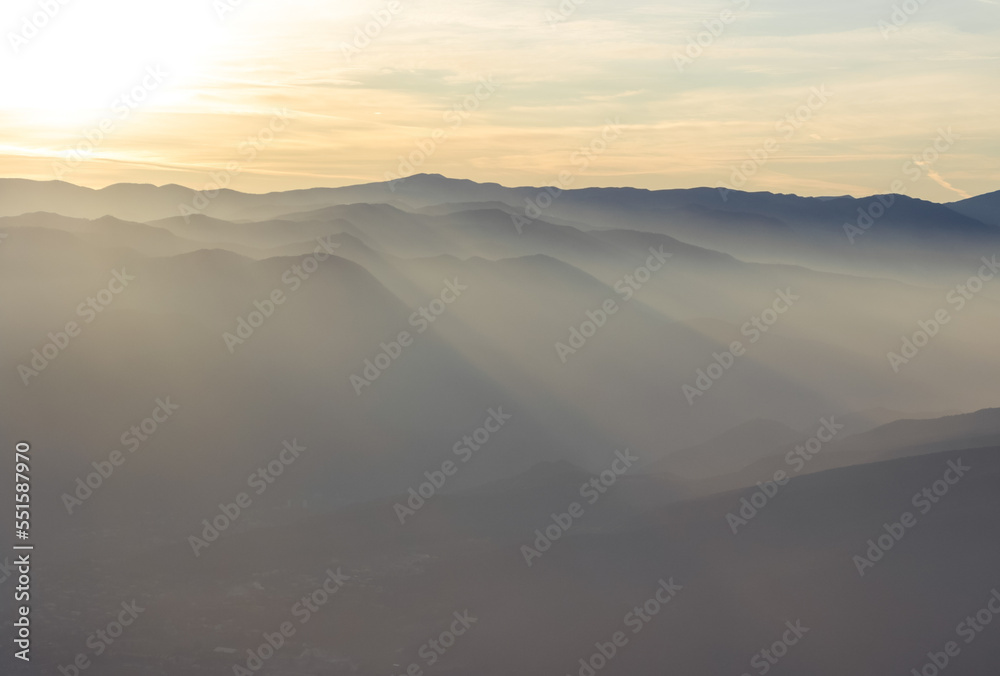 silhouettes of mountains in a haze in good weather