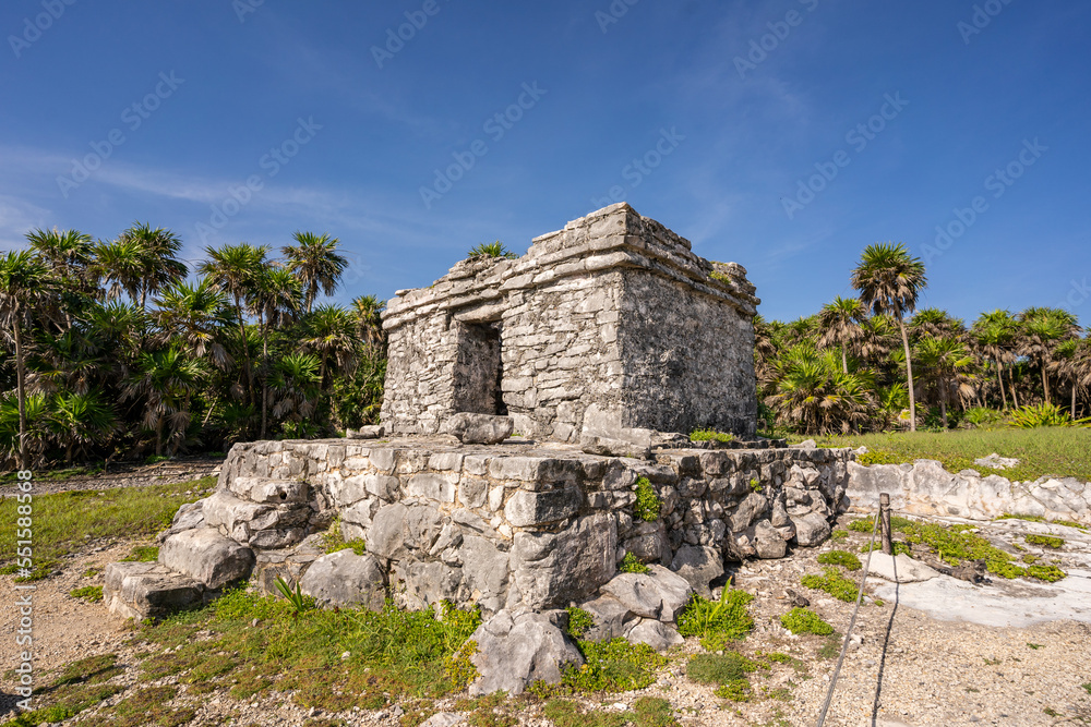 The ruins of a beautiful pyramid in the archaeological zone of Tulum in Mexico.
