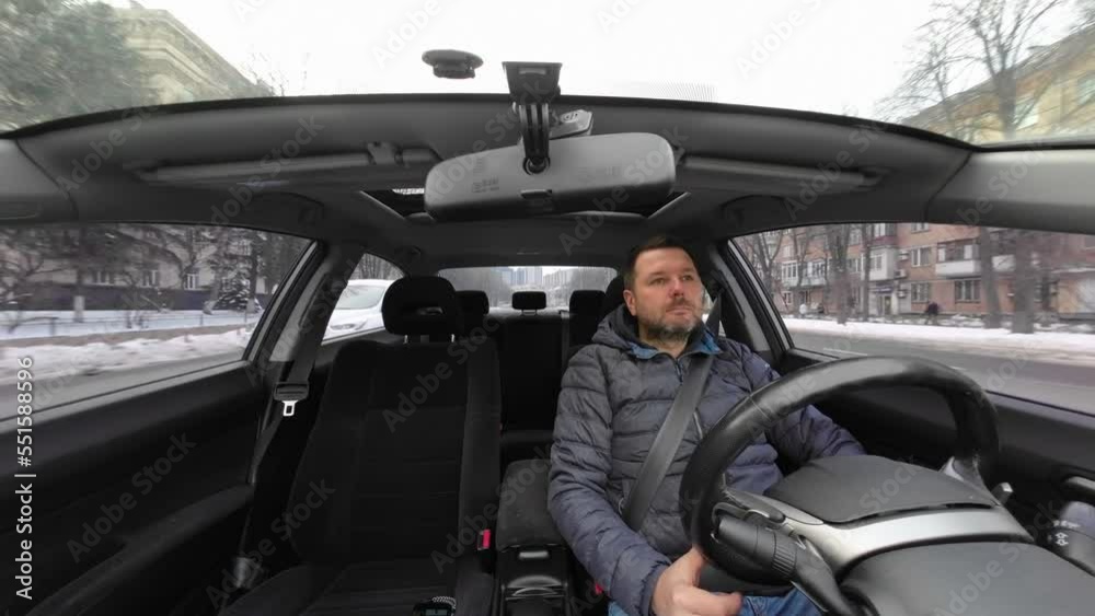 Man driving a car in the city cloudy winter day. Man driving a car in the city cloudy winter day.