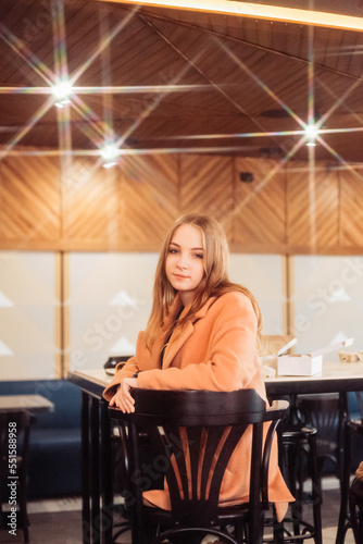 beautiful young woman sitting in a cafe