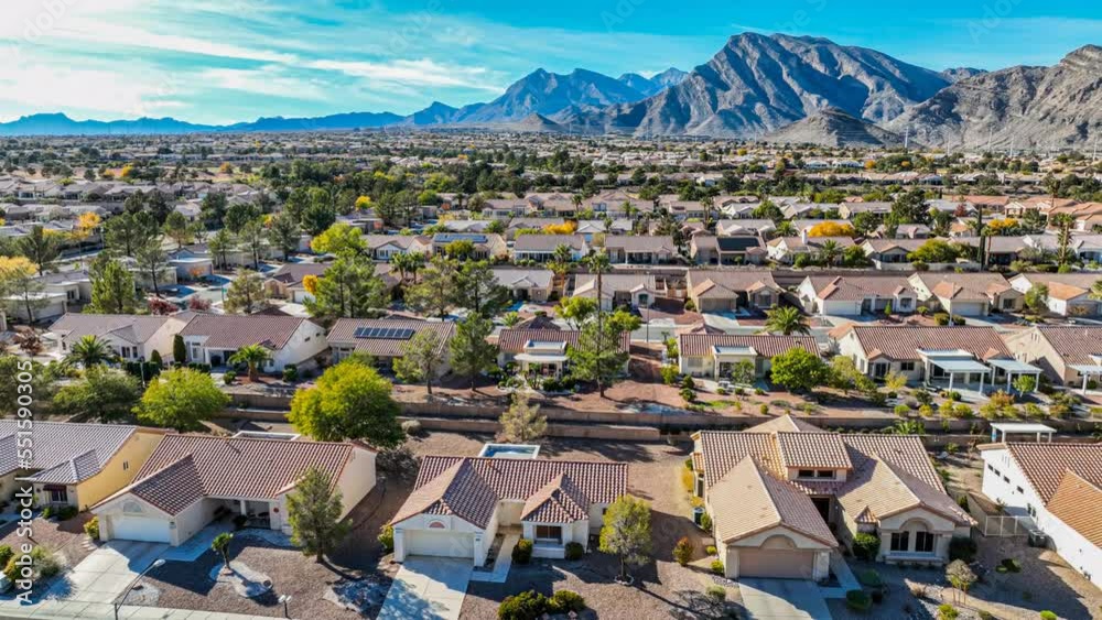 Flying over a southwestern suburban neighborhood with red tile rooftops