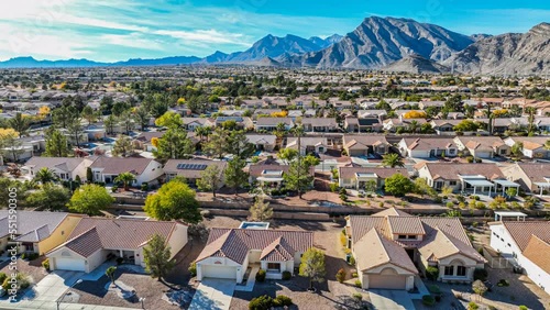 Flying over a southwestern suburban neighborhood with red tile rooftops
