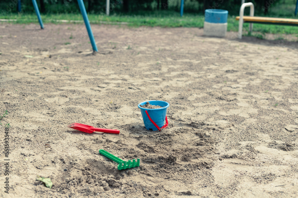 Sandbox with children's bucket, shovel and rake
