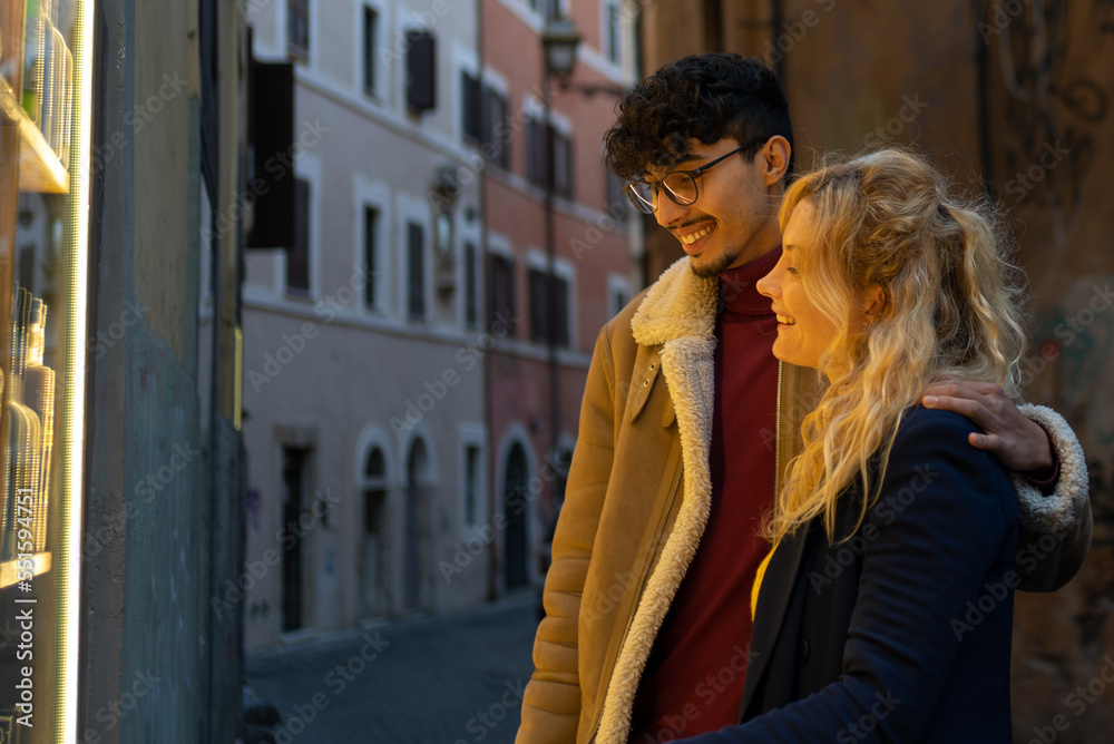 Multiethnic couple looking at a shop window Multiethnic couple looking at a shop window