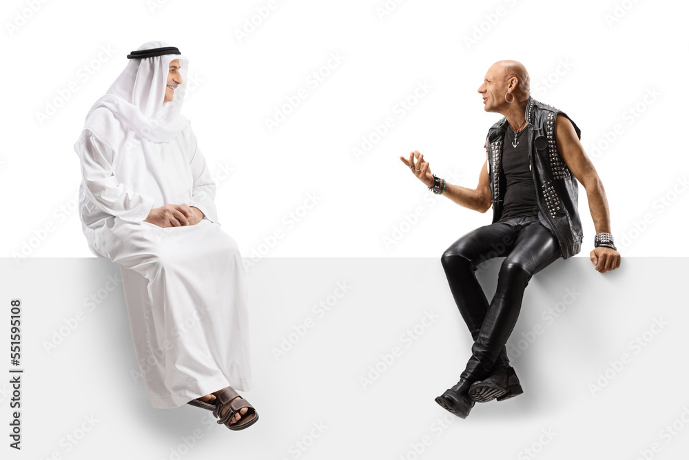 Arab man and a punk sitting on a panel and talking