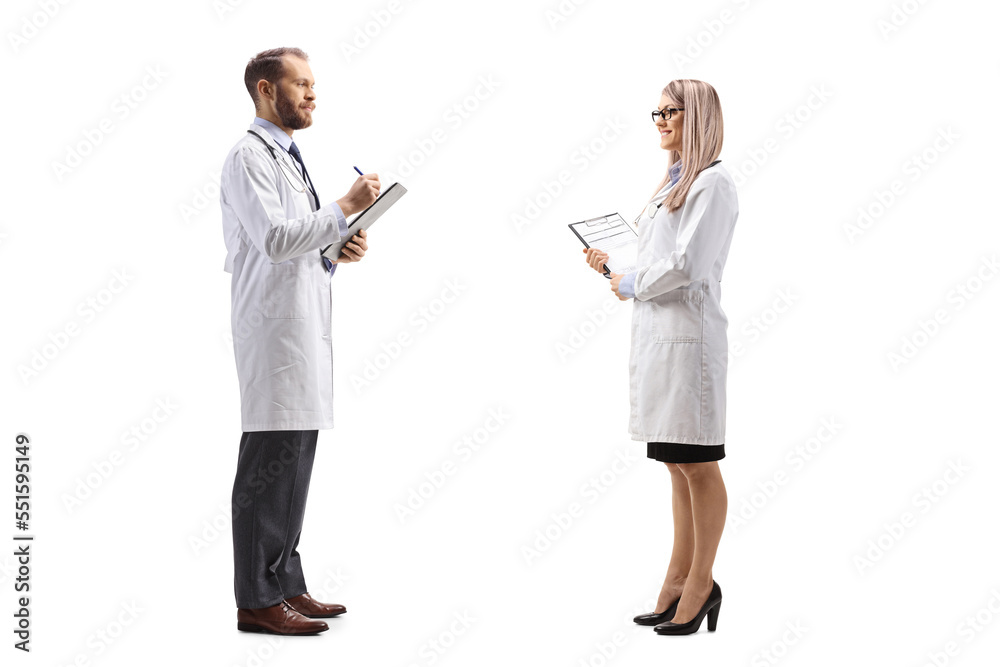 Doctor talking to a female colleague and writing a document Doctor talking to a female colleague and writing a document