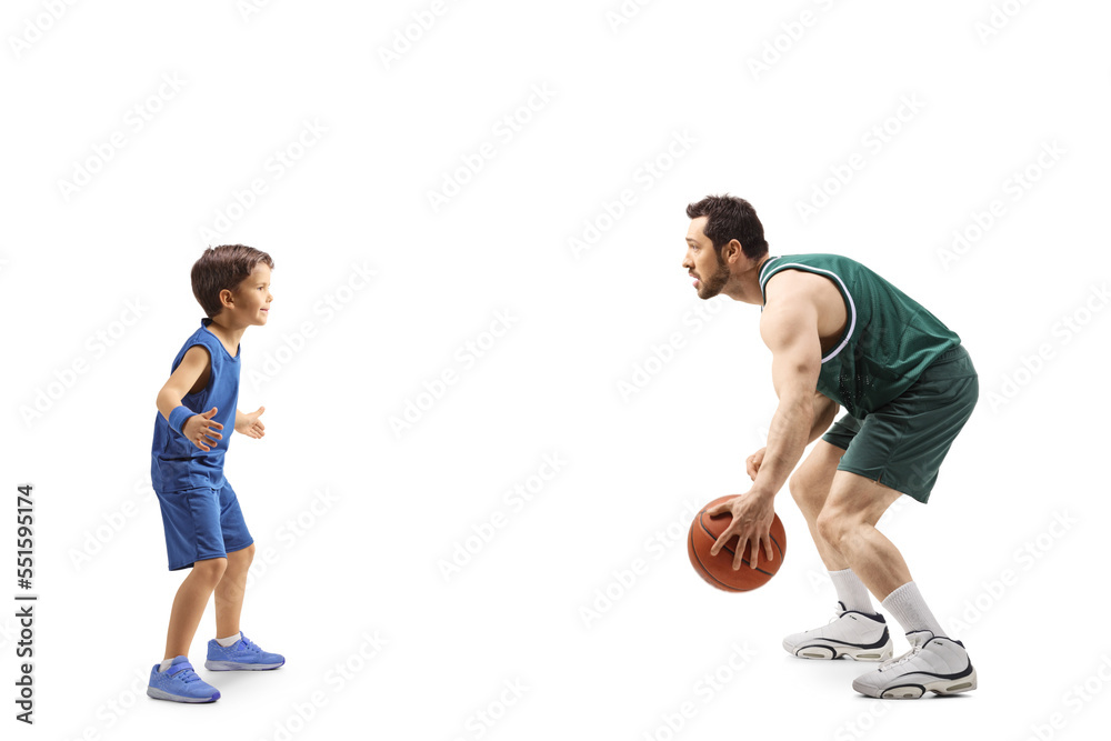 Full length profile shot of an adult playing basketball with a little boy