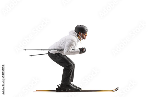 Full length profile shot of a male skier skiing photo