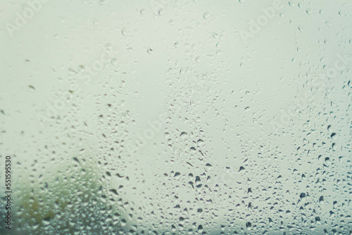 Drops on glass after rain. Autumn weather outside window. Rain outside window. © Verrone