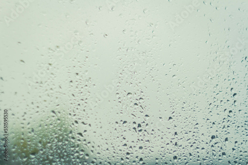 Drops on glass after rain. Autumn weather outside window. Rain outside window.